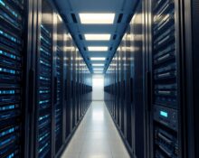 Aisle of server racks in a modern data center with one rack featuring AWS Trainium chip indicators.