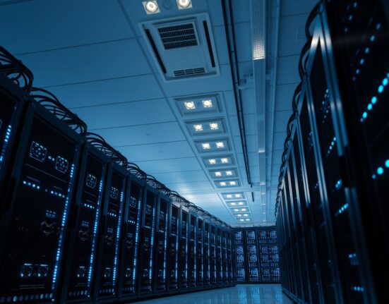 Interior view of a large-scale Bitcoin mining facility with rows of computer servers.