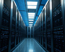 Interior of a modern data center with rows of server racks, representing AI compute infrastructure.