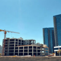 Construction cranes and building site in an Australian city under a clear sky