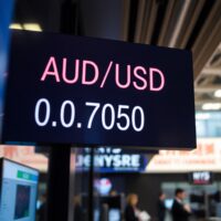 AUD/USD exchange rate display showing 0.7050 on a trading screen