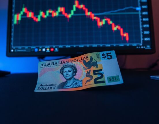 Australian Dollar banknote with a bearish financial chart in the background