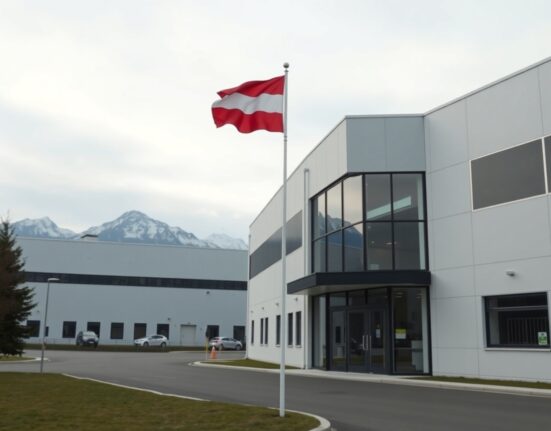 Exterior of an industrial factory in Austria with the Austrian flag, representing the country's producer price index data.