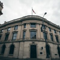 Bank of England building in London under overcast sky, representing UK monetary policy analysis.
