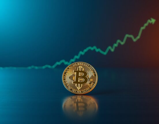 Bitcoin coin on a surface with a green upward-trending chart line representing the 200-day moving average breakout.