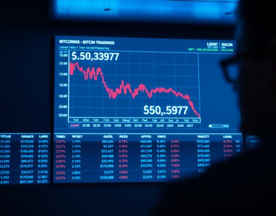 Bitcoin price chart approaching $60,697 liquidation level on a dark trading floor display.