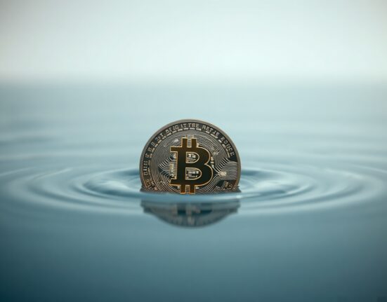 Bitcoin coin submerged in water representing an undervalued market zone