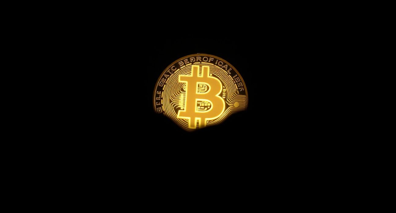 Bitcoin coin with shadow effect representing market decline
