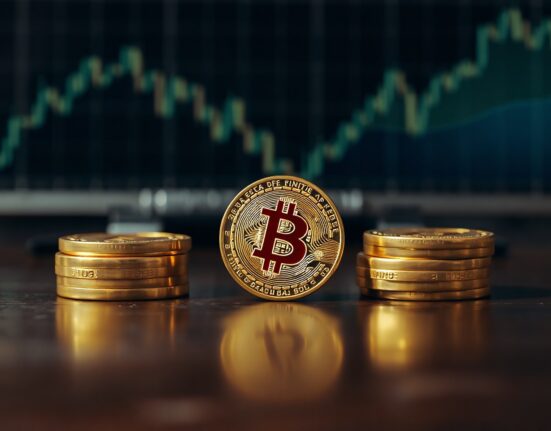 Bitcoin coin on a dark wooden table, symbolizing the recent price rise above $67,000.