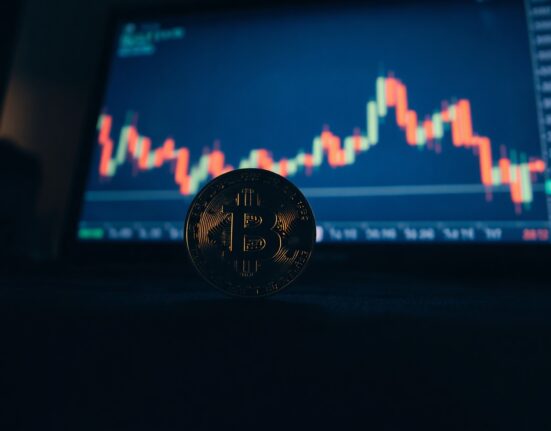 Bitcoin coin with a glowing chart in the background showing a bullish divergence pattern.