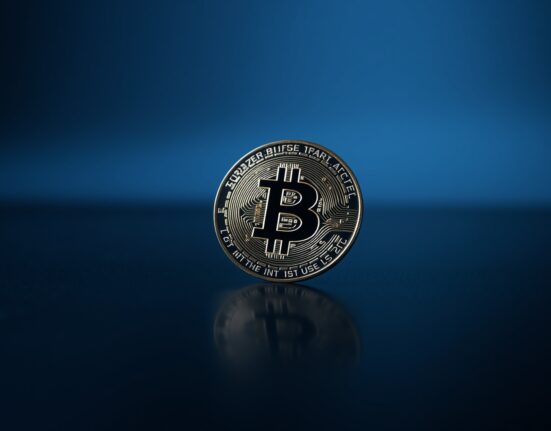 Bitcoin coin on reflective surface with chart overlay representing declining capital efficiency