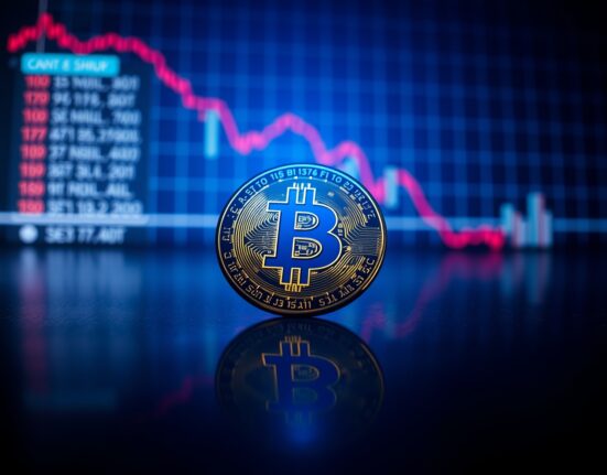 Bitcoin coin on dark surface with red downward trend line, representing bearish technical signal.