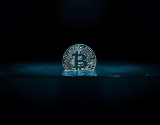 Bitcoin coin partially submerged in receding water symbolizing declining liquidity advantage