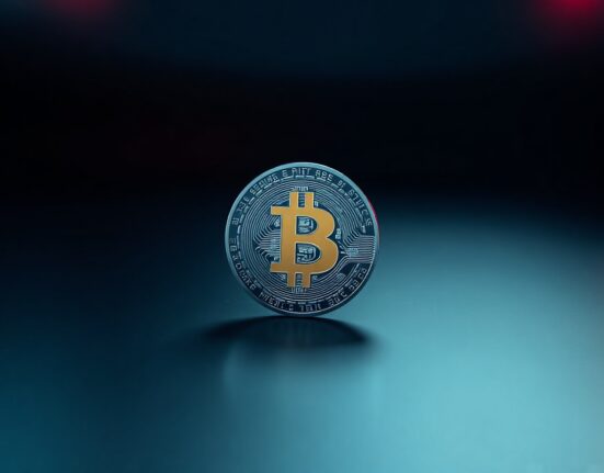 Bitcoin coin with red and blue lighting on dark background representing market liquidation risk