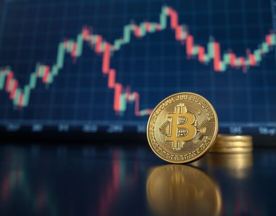 Bitcoin coin in focus with a blurred financial chart in the background
