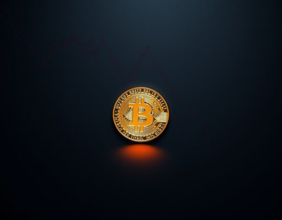 Bitcoin coin with a reflected downward trend line on a dark trading desk surface.