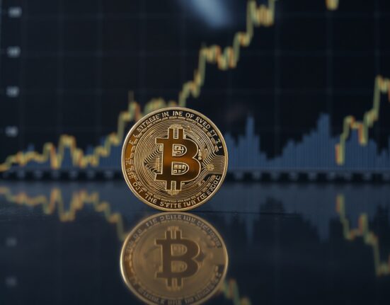 Bitcoin coin with upward price chart in background, representing market recovery