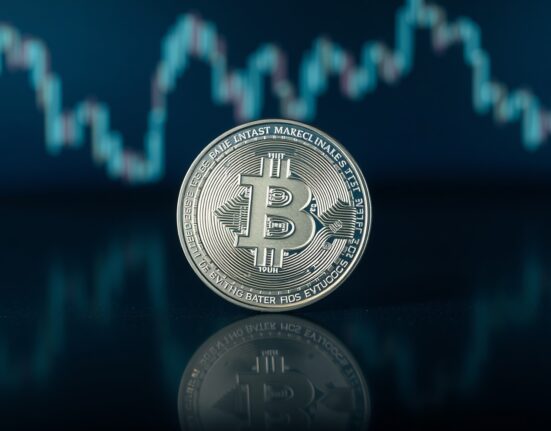 Bitcoin SV (BSV) coin on a dark surface with digital chart background.