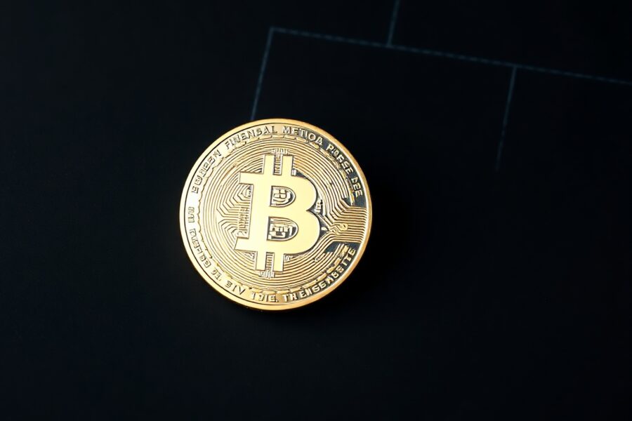 Bitcoin SV coin on reflective surface with green trend graph in background.