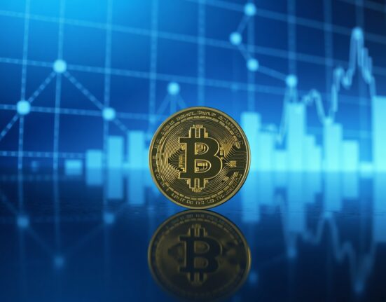 Bitcoin coin on reflective surface with digital network overlay, symbolizing whale transaction monitoring.
