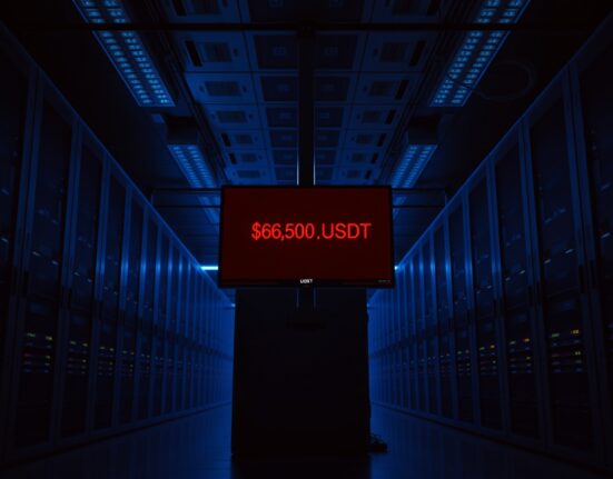 Dimly lit server room with monitor showing low USDT balance warning, representing BitMart liquidity concerns
