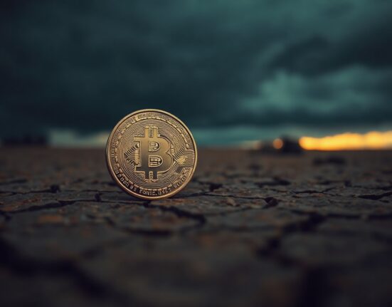 Bitcoin coin on cracked earth with stormy sky and golden horizon, representing macro risk and potential rebound