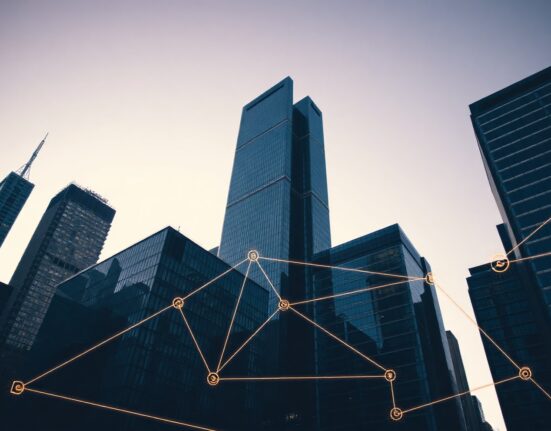 Modern financial district skyline with digital blockchain overlay representing tokenized assets