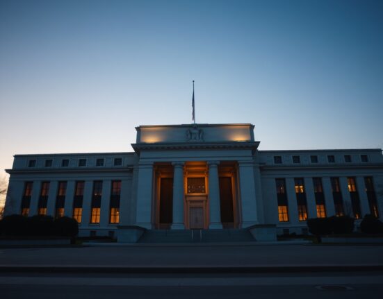 Federal Reserve building in Washington D.C. at dusk with warm lighting.