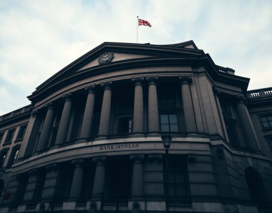 Bank of England building in London on a cloudy day, representing monetary policy decision