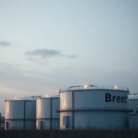 Brent crude oil storage facility at dusk representing easing inflation pressures