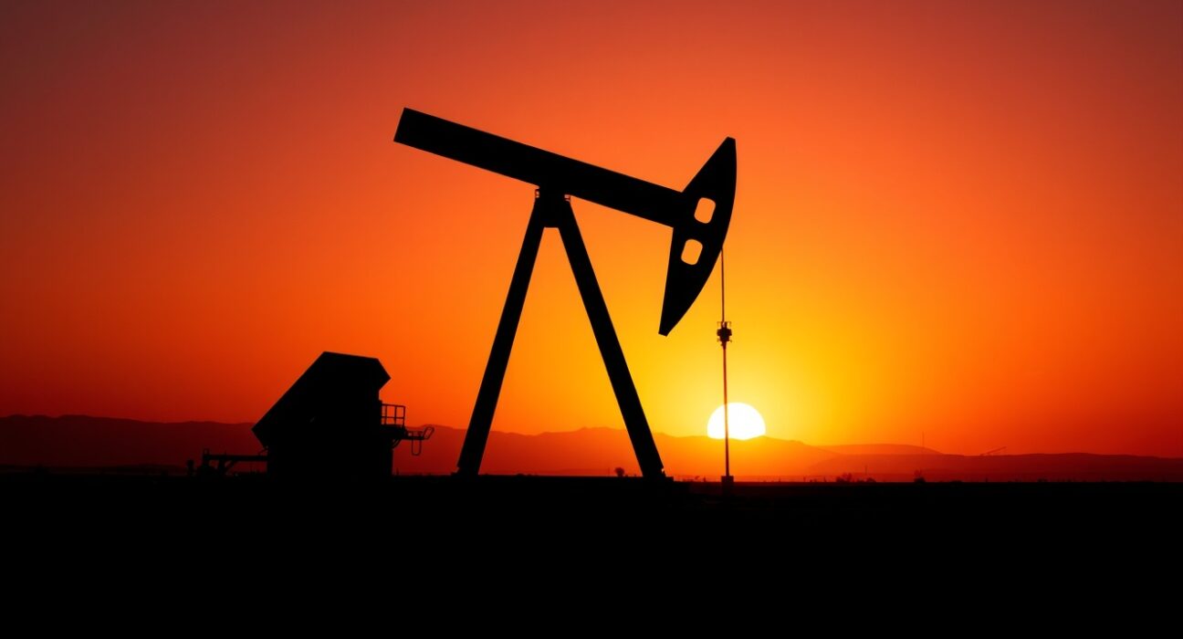 Oil pumpjack silhouetted against sunset sky, representing Brent crude market volatility and geopolitical risk