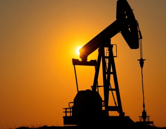 Oil pump jack silhouette at sunset, representing Brent crude supply risks and elevated prices.