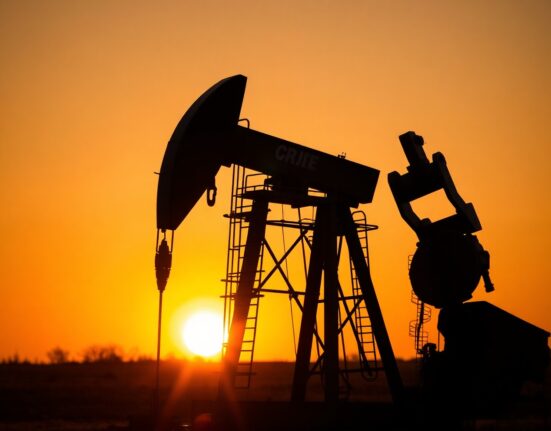 Oil pumpjack silhouetted against a sunset, symbolizing oil market shifts amid US-Iran peace deal optimism.