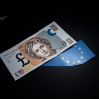 British pound and euro banknotes on a desk, representing currency market volatility amid UK political uncertainty.