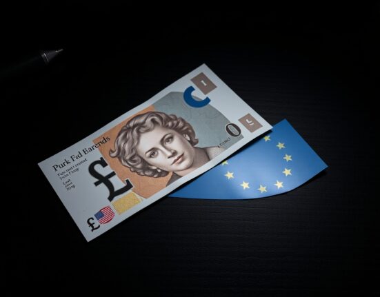 British pound and euro banknotes on a desk, representing currency market volatility amid UK political uncertainty.