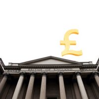 Bank of England building with a subtle gold pound sterling symbol in the sky, representing currency market gains.