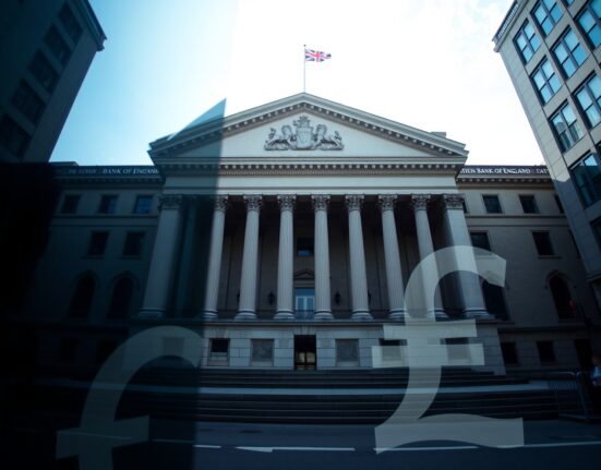 Bank of England building in London with British Pound symbol in foreground