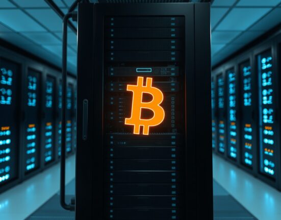Bitcoin symbol in a data center server room representing a large cryptocurrency transaction.