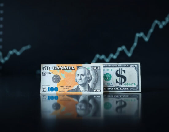 Canadian and US dollar banknotes with a rising chart symbolizing bullish CAD forecast