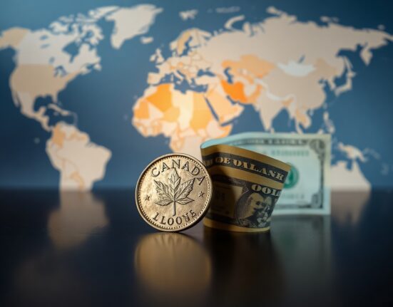 Canadian Dollar and US Dollar banknotes on a reflective surface with a blurred world map background, symbolizing forex market consolidation amid geopolitical tensions.