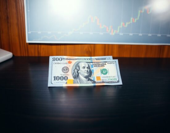 Canadian and US dollar banknotes on a desk with financial chart background near 1.40 level