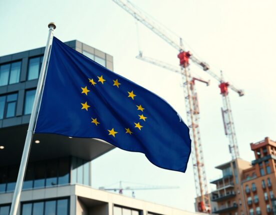 EU flag flying in front of a government building with construction cranes in the background, symbolizing recovery fund projects.