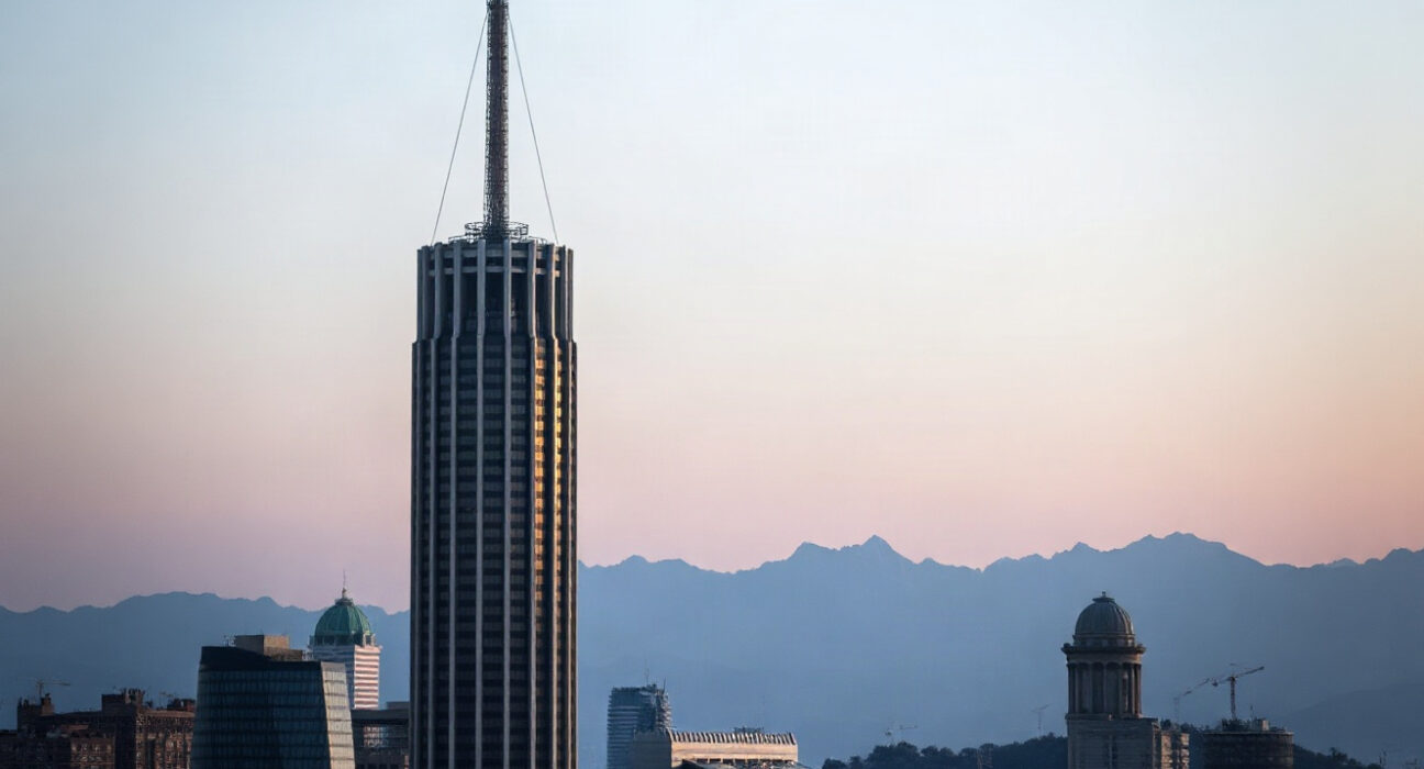 Santiago, Chile skyline at dusk with Andes mountains, symbolizing economic activity.