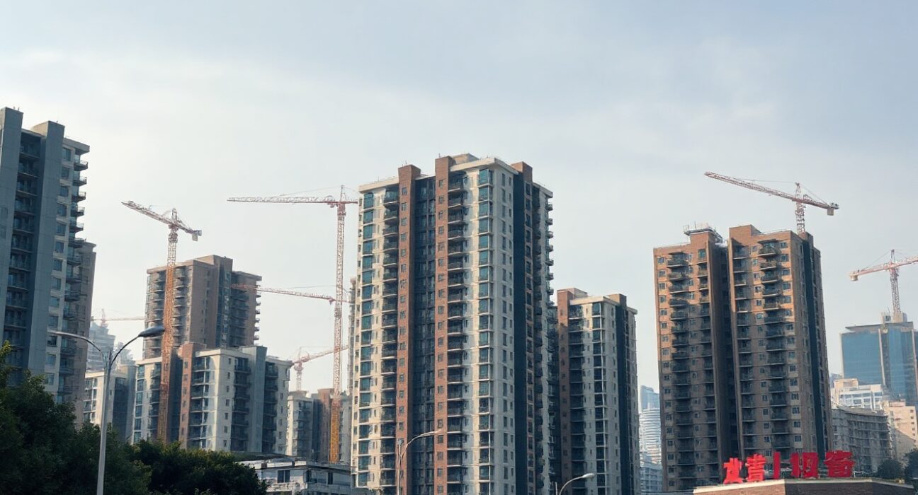Residential buildings in a Chinese city under clear sky, representing the property market
