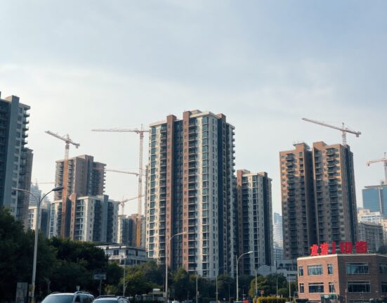 Residential buildings in a Chinese city under clear sky, representing the property market