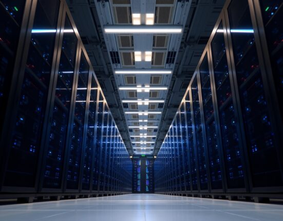 Interior of a modern AI data center with rows of server racks and blue lighting