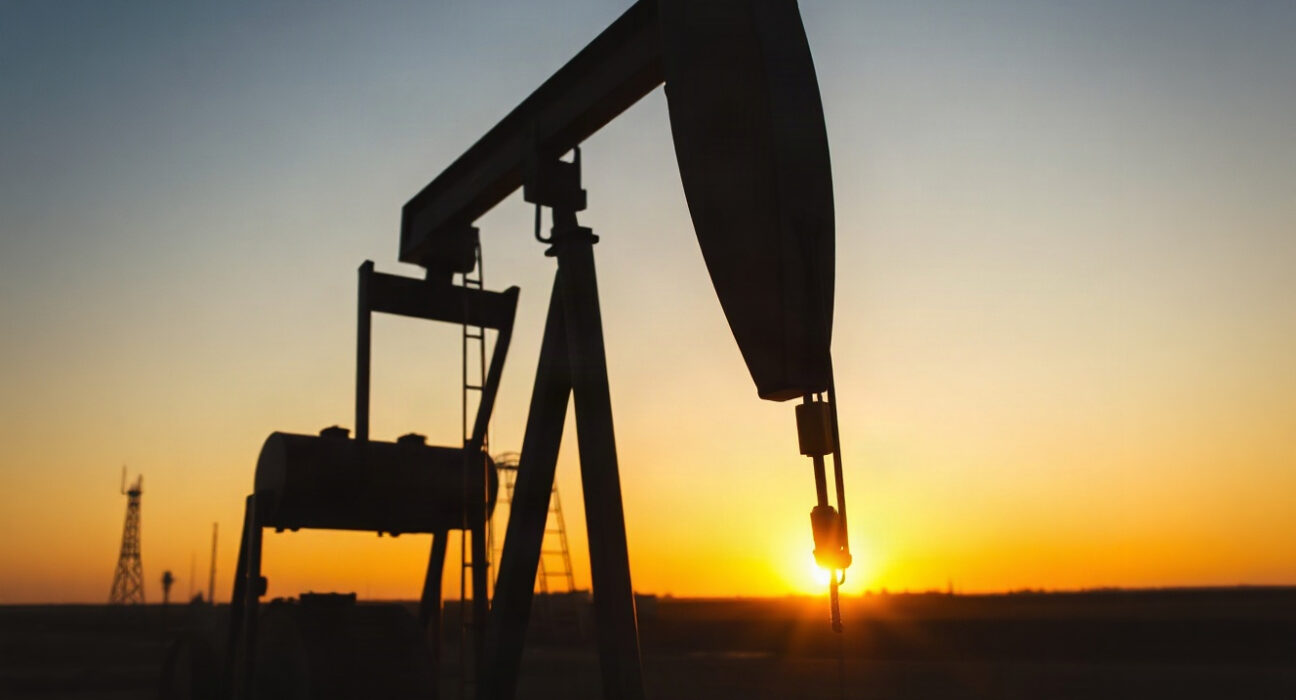 Crude oil pumpjack silhouette at sunset representing energy market analysis and USD/CAD impact
