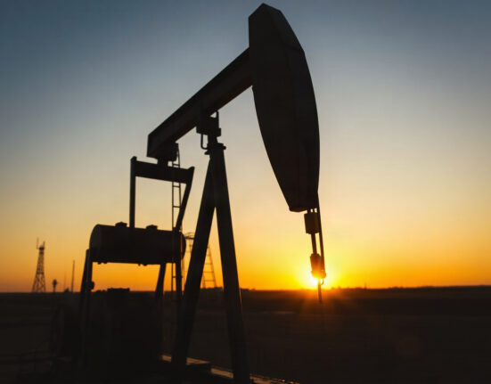 Crude oil pumpjack silhouette at sunset representing energy market analysis and USD/CAD impact
