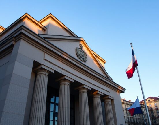 Exterior of the Czech National Bank building in Prague during late afternoon sunlight.