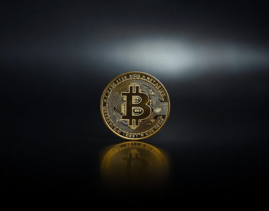 A Bitcoin coin on a dark surface, representing a dormant whale wallet moving funds after 12 years.